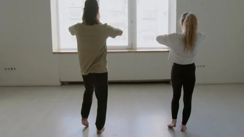 Dancers Doing Hip Opener Exercise in Studio Stock Footage 282525628