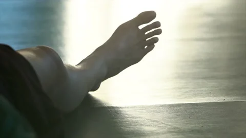 Dancers foot lying on the floor on the background of movers. low view Stock Footage 150270592