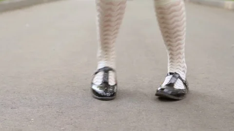 Dancer's legs close-up loop. Girl dancing solo jazz swing dance on the city's Video stock 71345573