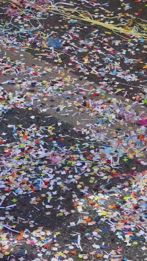 Dancers legs stepping on confetti covered asphalt during a carnival parade Stock Footage 345036880