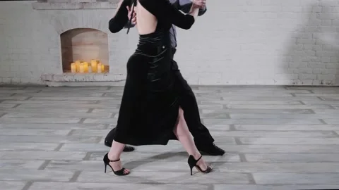 Dancers perform Argentinian tango near decorative fireplace Stock Footage 135954732