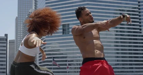 Dancers performing their routine against a cityscape Stock Footage 97240281