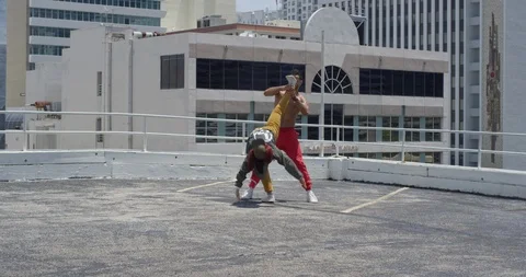 Dancers performing their routine on top of a parking garage Stock Footage 97239373