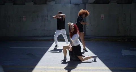 Dancers performing their routine under an overpass Stock Footage 97033784