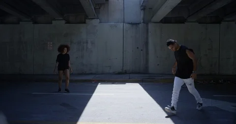 Dancers performing their routine under an overpass Stock Footage 97034116