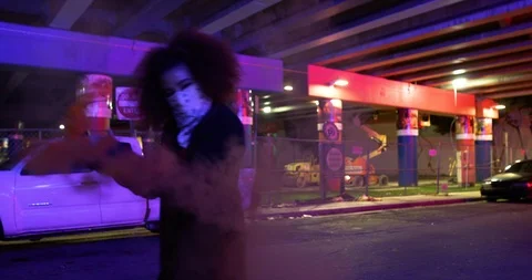 Dancers performing their routine under an overpass at night with smoke bombs Stock Footage 100182881