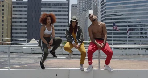 Dancers posing against a cityscape Stock Footage 97036437