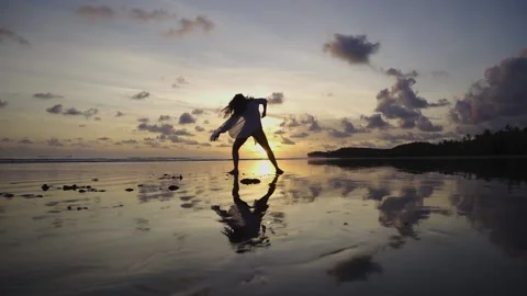 Dances on the beach over a spectacular sunset Stock Footage 151703369