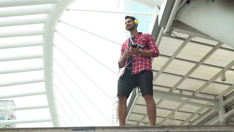 Dancing 4K Handsome guy listening music and dancing in the city with feeling Stock Footage 137443766