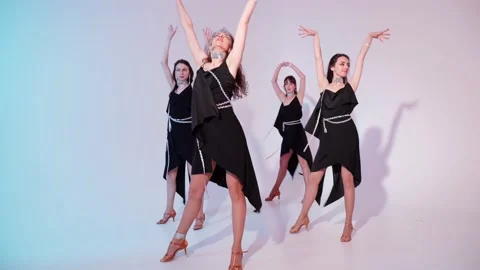 A dancing aerobic class of a women's modern dances. A group of girls are dancing Stock Footage 152920430