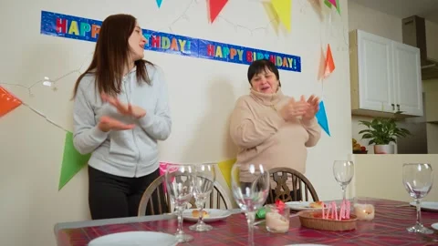 Dancing and clapping hands during birthday celebration. Mother and daughter Stock Footage 303285907