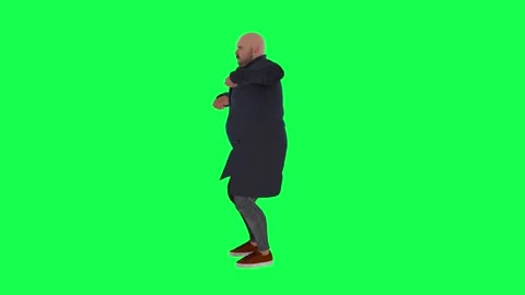 Dancing and impersonating a man in a navy overcoat from the right view on a gree Stock Footage 243448064