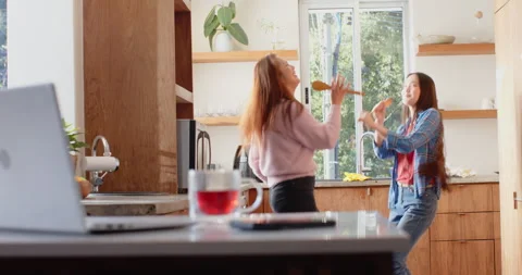 Dancing and singing in kitchen, asian mother and daughter enjoying quality time Video stock 297525418