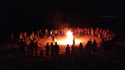 Dancing around the fire (aerial view). Stock Footage