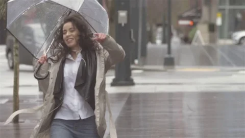 Dancing around with an umbrella in the city while listening to music Stock Footage 82960932