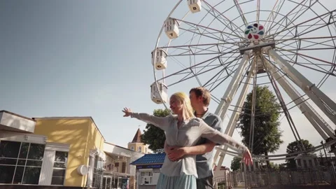 Dancing on the background of a ferris wheel. Stock Footage 133312809