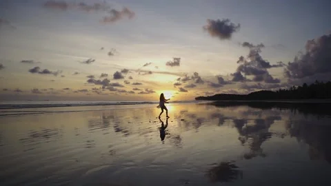 Dancing on the beach at sunset with reflections Stock Footage 151412778