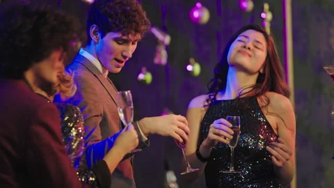 Dancing beautiful young people in front of the camera at stuff party they Video stock 144488688