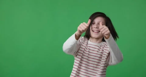 Dancing boy showing thumbs up on green screen Stock Footage 243439085