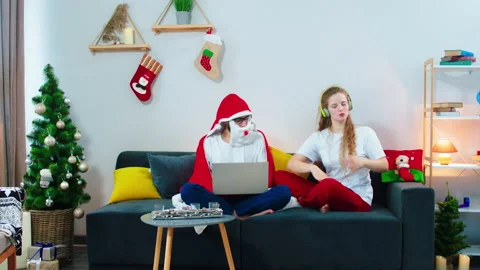 Dancing charismatic woman while sitting on the the sofa she wearing headphones Stock Footage 160799230