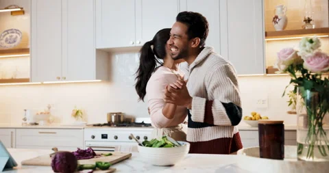 Dancing, cooking and couple in kitchen at house listening to music, playlist or Stock Footage 343645691