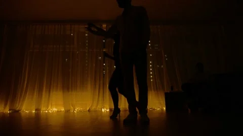 Dancing couple silhouette in intimate setting.salsa practice in the studio Stock Footage 218602506