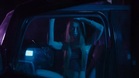 Dancing in a crossover car: Attractive long hair hot blonde girl in blue and Video stock 122501151