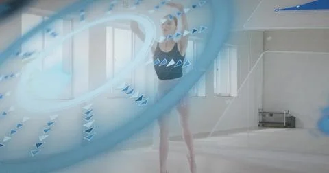 Dancing dancer in black leotard and short skirt, in pointe shoes in studio with Stock Photos