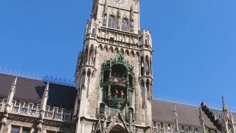 Dancing dolls which are part of famous clocks on New Town Hall in Munich Stock Footage 107484897
