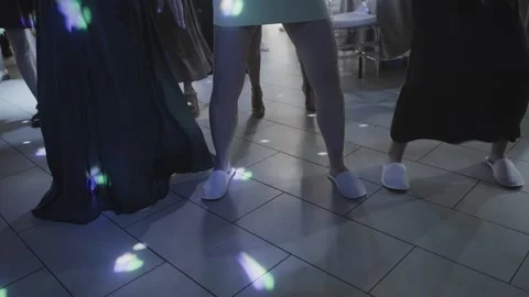 Dancing feet on the dance floor illuminated by spotlights Stock Footage 329248403