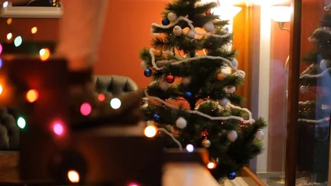 Dancing feet on glowing staircase on the background of the Christmas tree. Stock Footage 70738986