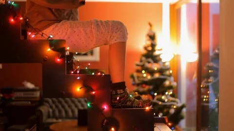 Dancing feet on glowing staircase on the background of the Christmas tree. Stock Footage 70767115