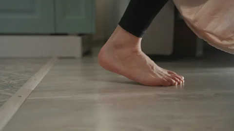 Dancing feet joyfully. Rhythmic steps on tiled floor. Energetic barefoot dance Stock Footage 342061964