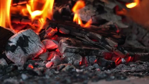 Dancing flames and vibrant sparks create an enchanting glow that lights up Stock Footage 296515668