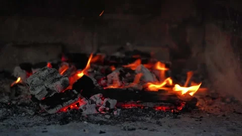 Dancing flames and vibrant sparks create an enchanting glow that lights up Stock Footage 296515669