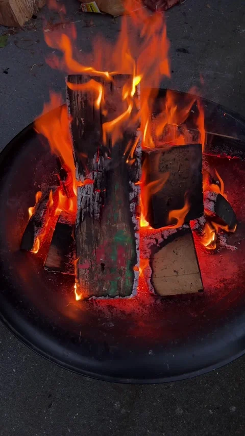 Dancing flames in a metal fire pit Stock Footage 326354347