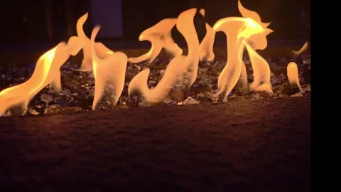 Dancing Flames Over Decorative Fire Glass in Modern Gas Fire Pit Stock Footage 338366526