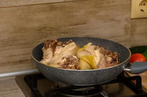 Dancing flavors in a warm kitchen as tender chicken simmers with vibrant sp.. Stock Photos