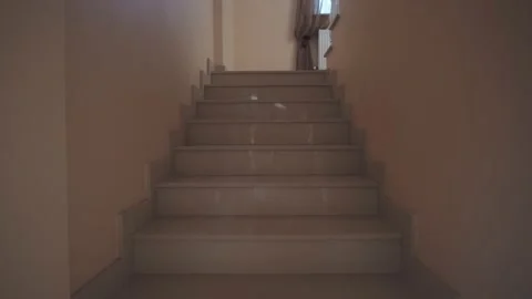 Dancing funny guy with a sunglasses in the house at second floor stairs with a Stock Footage 137786673