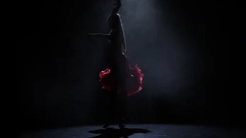 Dancing girl silhouette with smoke on a dark background. Slow motion Stock Footage