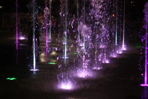 Dancing Ground Fountain with Variable Water Jets at Night Stock Photos