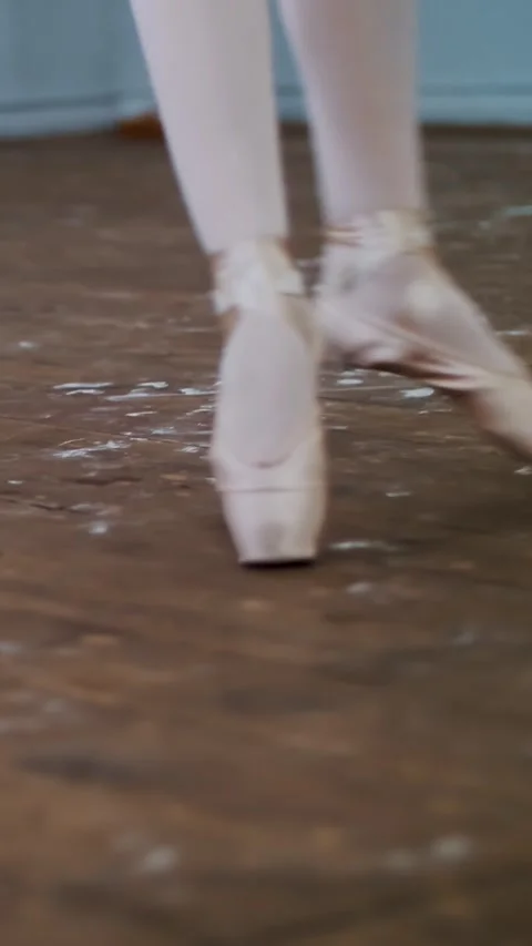 In dancing hall, Young ballerina in black leotard performs glissade en tournant, Stock Footage 313346039