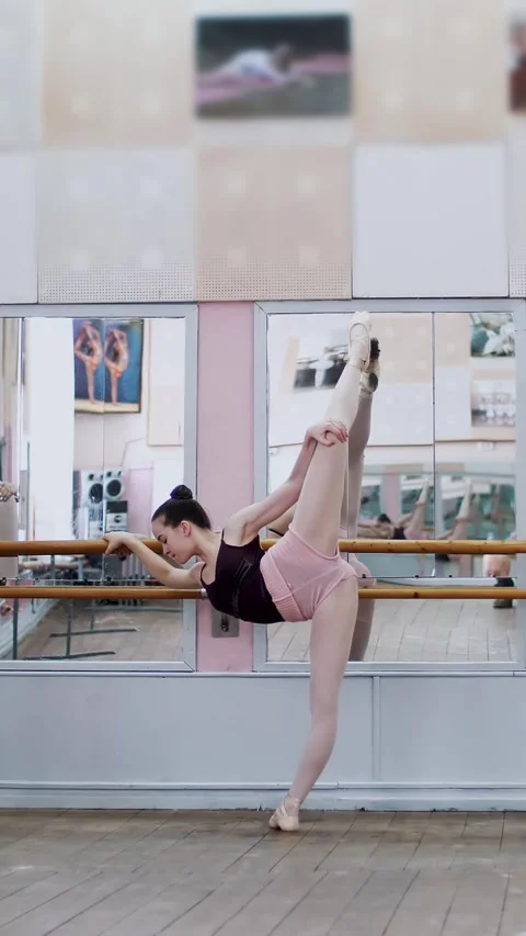 In dancing hall, Young ballerinas in black leotards are stretching, standing Stock Footage 314656873