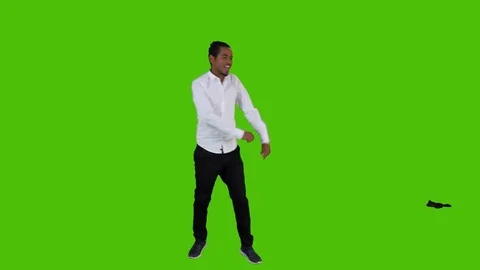 Dancing happily by a young bsinessman over a green screen. Stock Footage 82470065