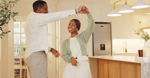 Dancing, happy and couple in kitchen at house with music for bonding, love .. Stock Photos