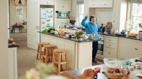 Dancing, headphones and man in kitchen with energy for performance, audio or Stock Footage 335801754