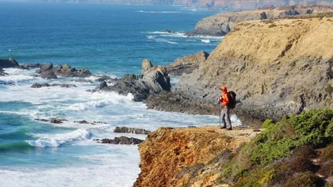 Dancing hiker on dramatic coastal cliffs of Portugal Stock Footage 319674231
