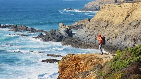 Dancing Hiker on Rocky Cliffs Above the Atlantic Waves Portugal Stock Footage 319313867