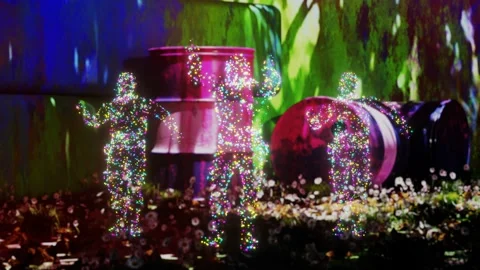 Dancing holograms of people in a barrel dump. VJ Loop Stock Footage 202367584