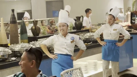 Dancing hotel chefs entertain dinner guests Stock Footage 232635721